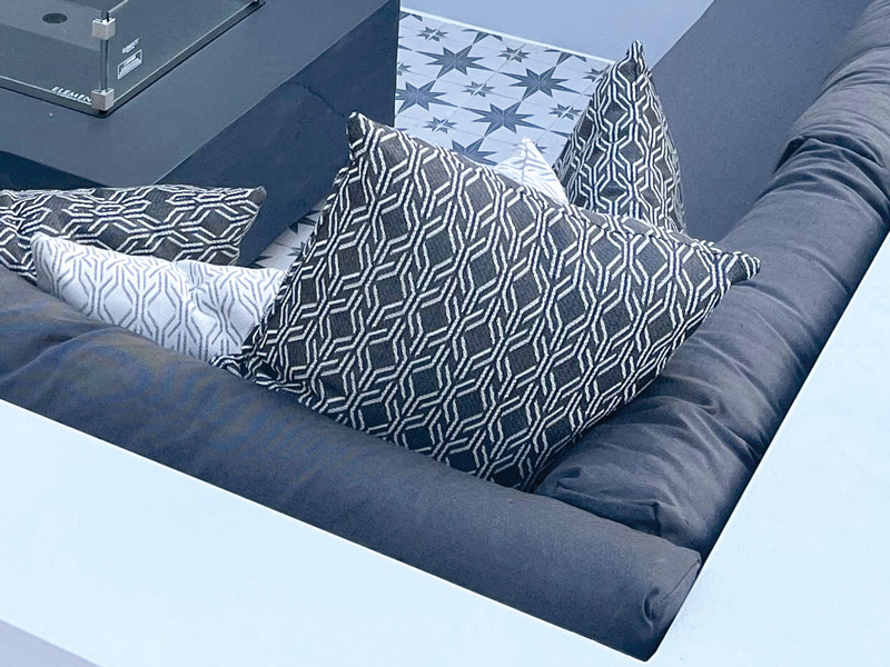 Recovered outdoor cushions for an exterior wicker furniture suite